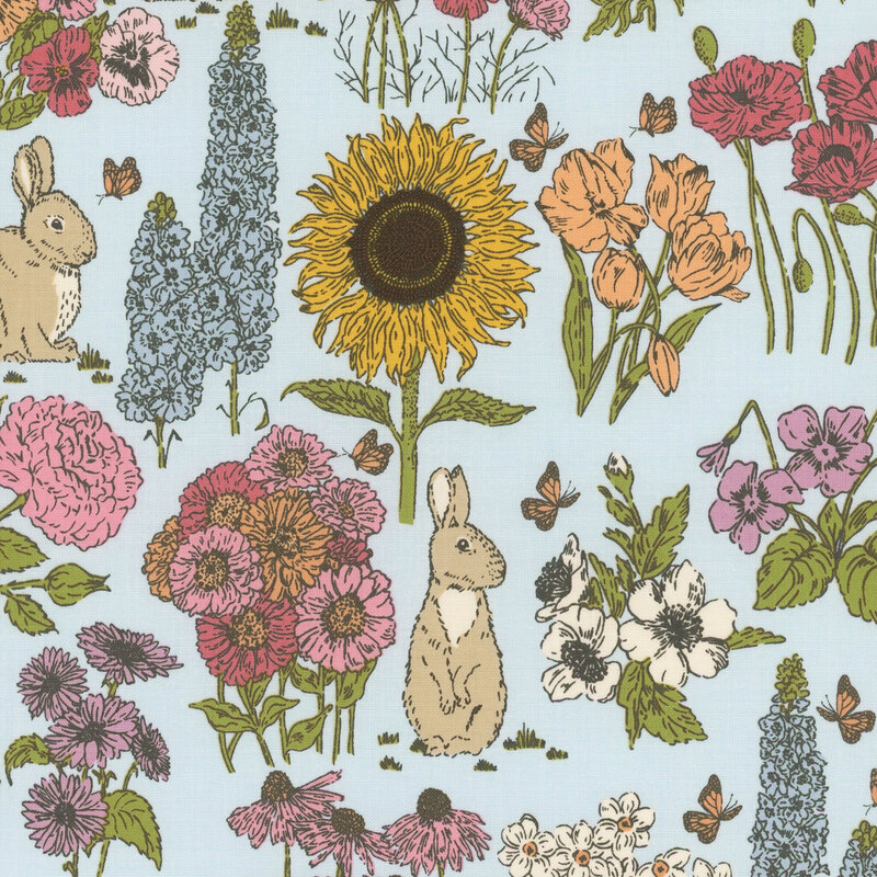 Blue fabric featuring a garden of blooming flowers and bunnies.