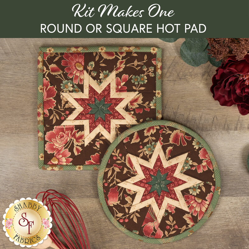 The two completed brown Folded Star Hot Pads, one round and one square, slightly overlapping each other and staged on a wooden table with coordinating floral décor.