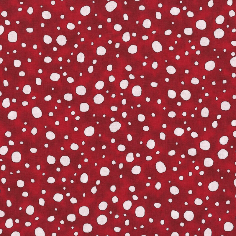 Falling snow on a mottled red fabric.