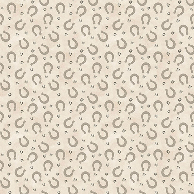 Mottled cream fabric with a scattered pattern of horseshoes and abstract spurs.