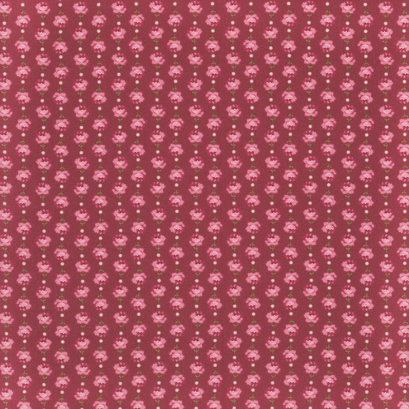 Vertical columns of roses alternating in direction on wine red fabric.