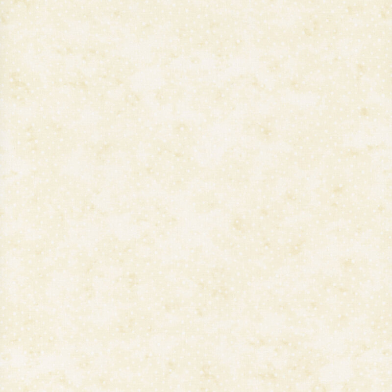 A mottled cream fabric with small white polka dots. 
