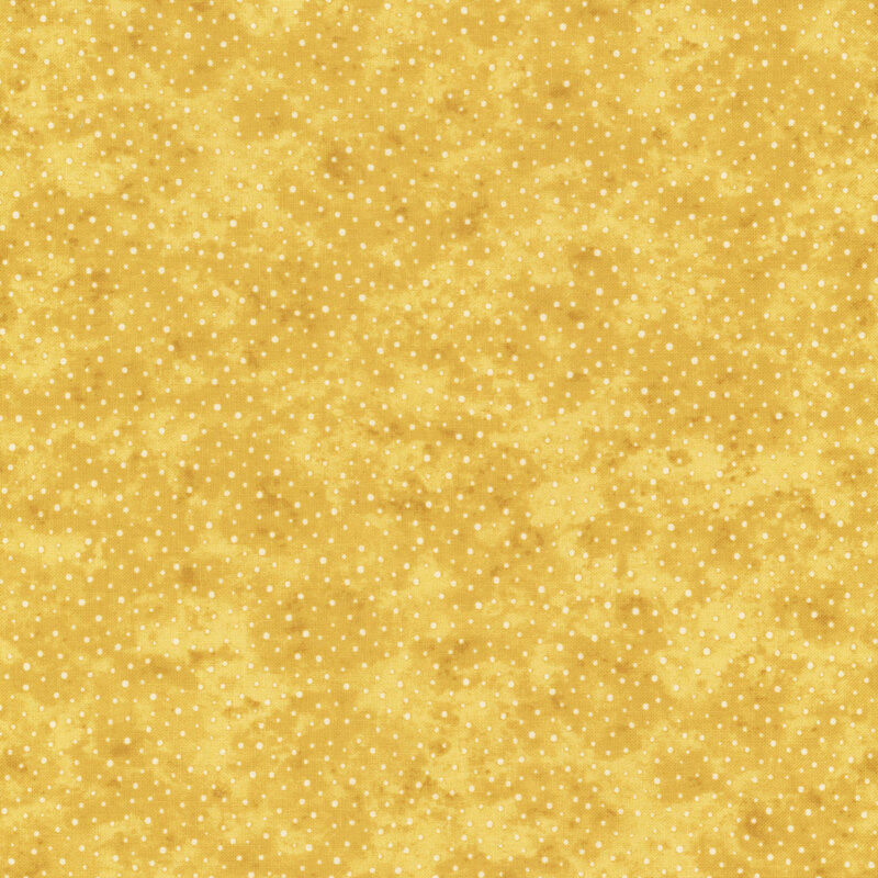 A mottled golden fabric with small white polka dots. 