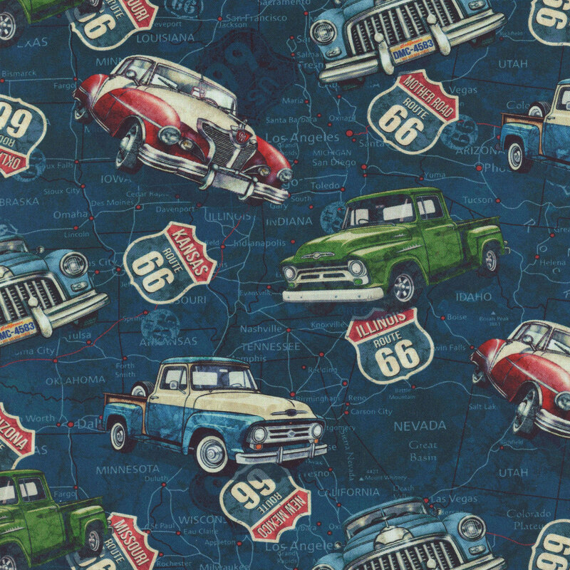 map design on textured navy blue fabric with a tossed pattern of vintage cars and trucks, and highway signs