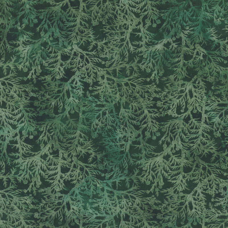 Dark green fabric covered in evergreen branches.