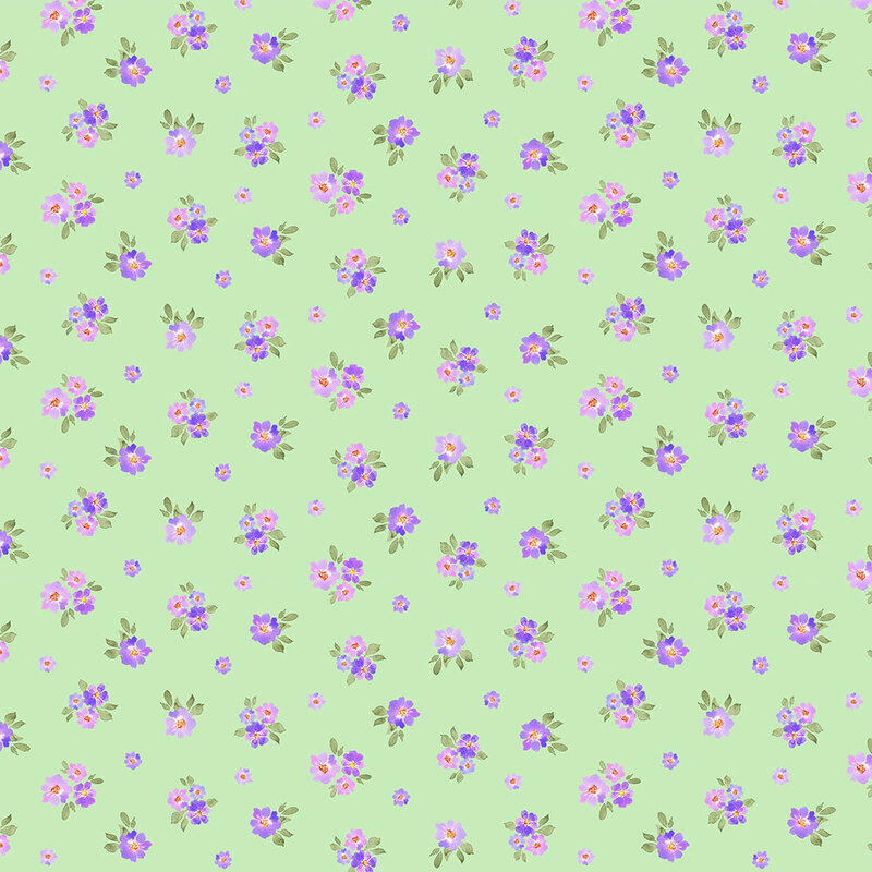 A spring green fabric with tossed purple flowers and green leaves in a watercolor style. 