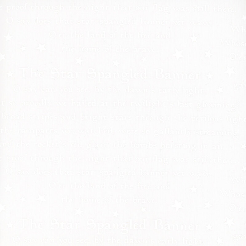 A white on white fabric featuring the Star Spangled Banner National Anthem surrounded by stars.