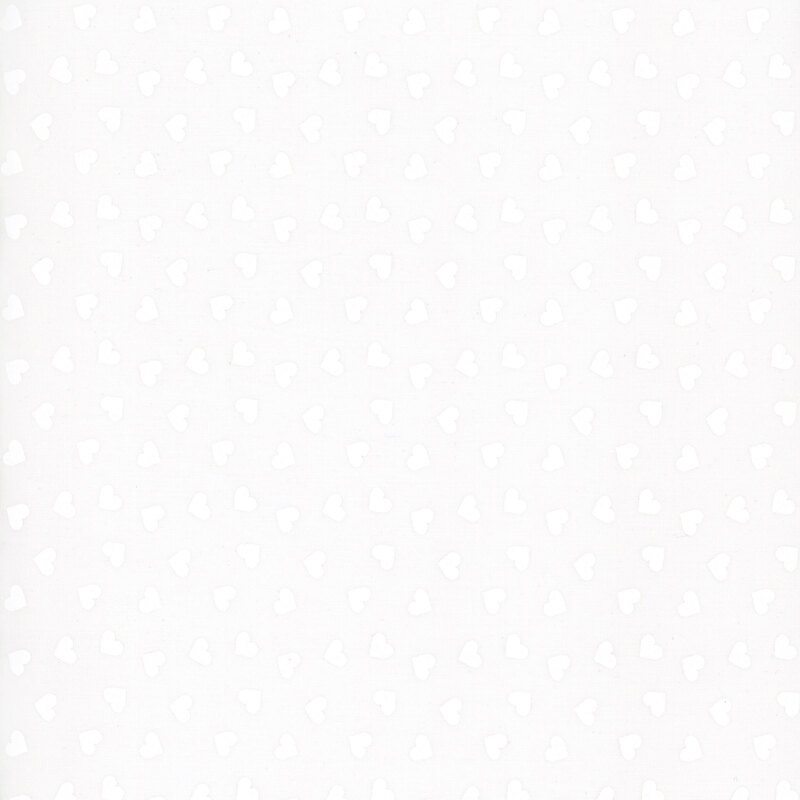 A white on white fabric tossed with hearts.