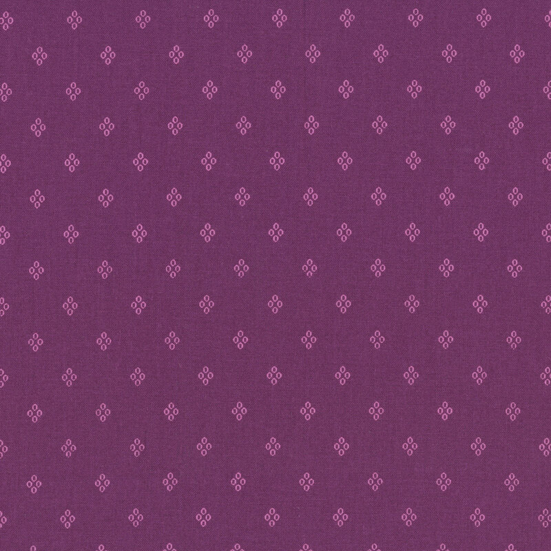 Dark magenta fabric with a pattern of pink diamond shaped circles