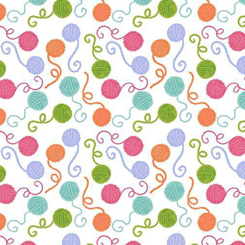 White fabric featuring colorful balls of unspooling yarn.