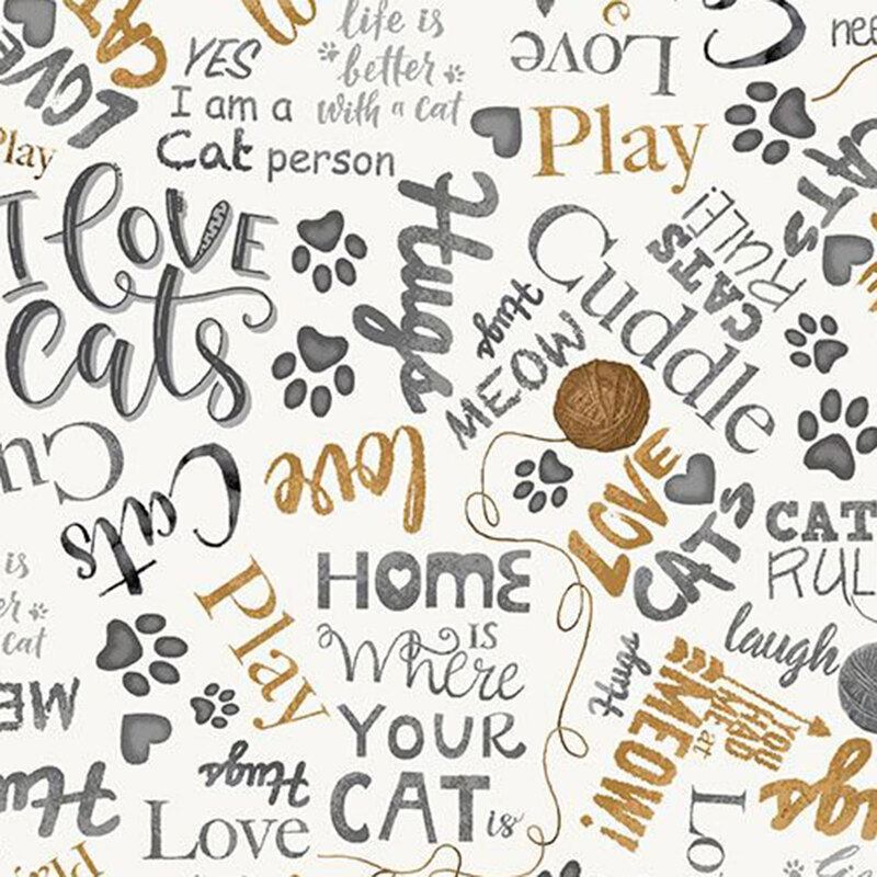White fabric with cat-loving phrases in gray and gold colors, balls of yarn, and paw prints.