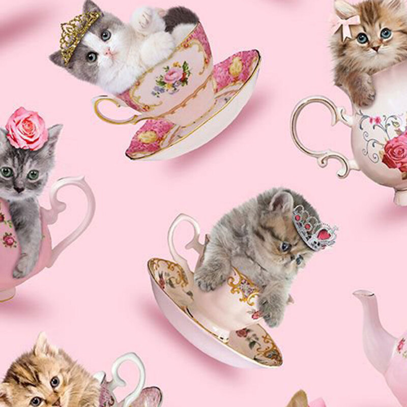 Kittens with bows, roses, and tiaras resting inside delicate teacups on a light pink background.