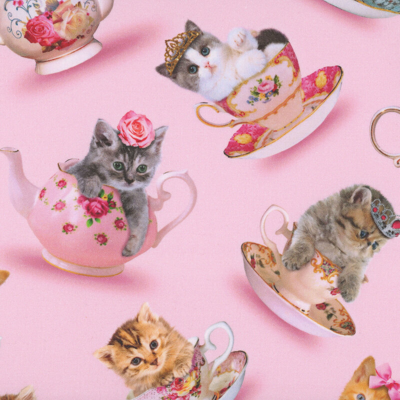 Kittens with bows, roses, and tiaras resting inside delicate teacups on a light pink background.
