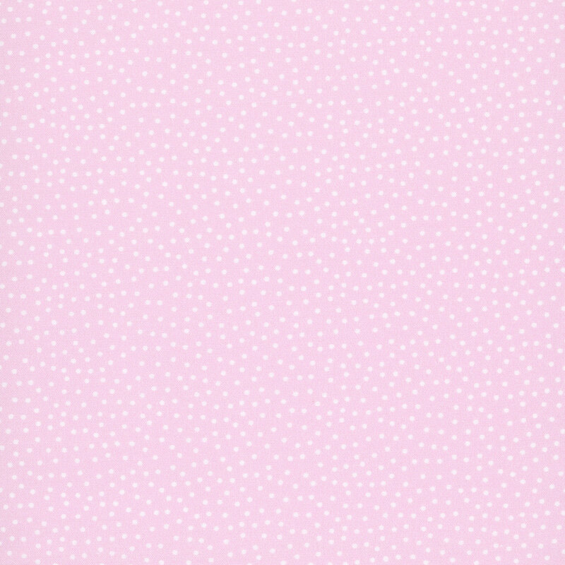 Pastel pink fabric with a pattern of white dots