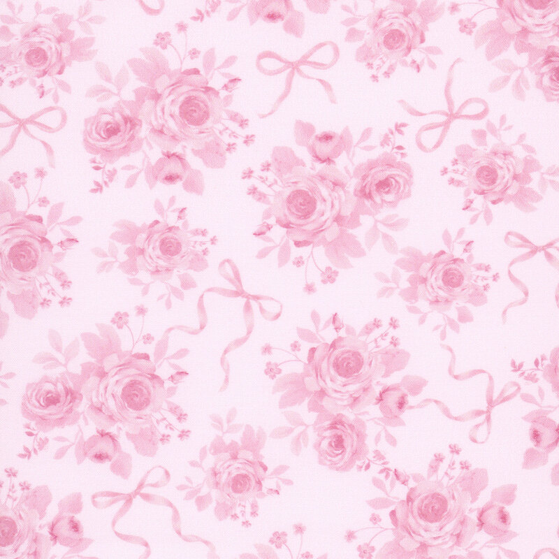 Light blush pink fabric with a tossed pattern of pink bows and pretty rose bouquets. 