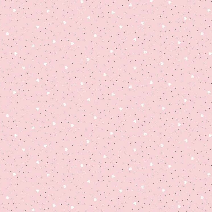 A pastel pink fabric with tossed white hearts and dark polka dots. 