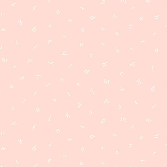 A pastel pink fabric with a tossed design of the alphabet.