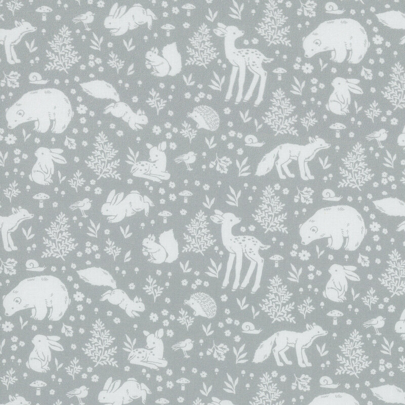 A tonal gray blue fabric with motifs of woodland animals surrounded by flowers, fern leaves, and mushrooms.