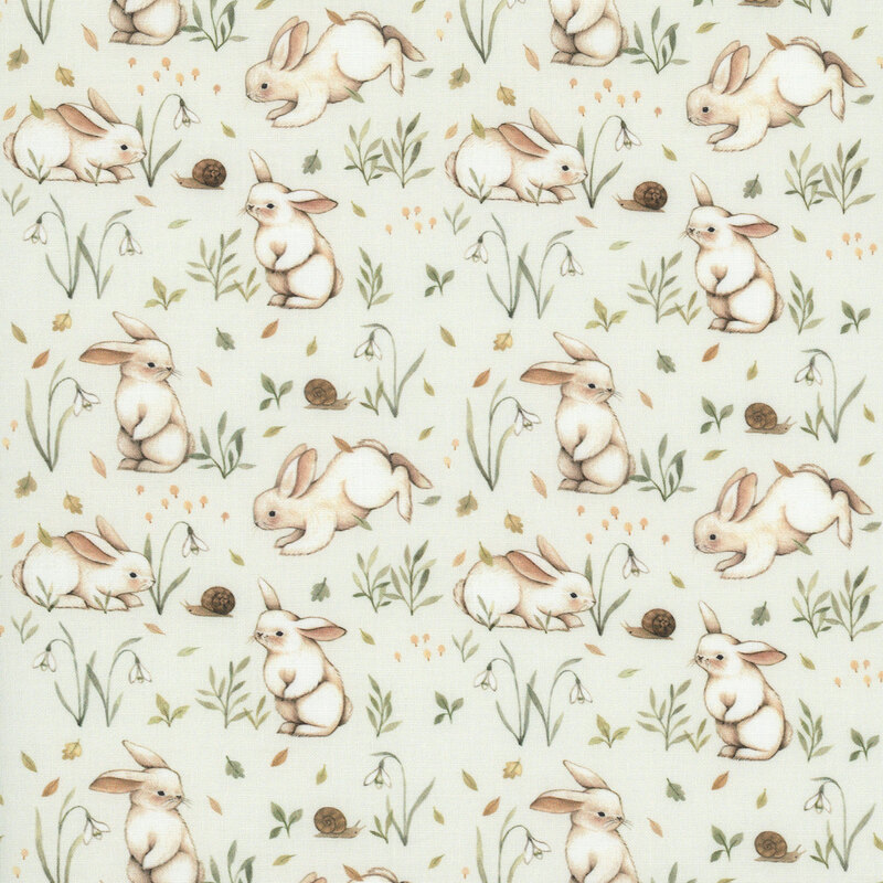 A light beige fabric with bunnies surrounded by grass, sprigs, and snails. 