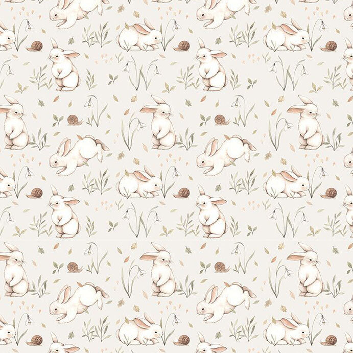 A light beige fabric with bunnies surrounded by grass, sprigs, and snails. 
