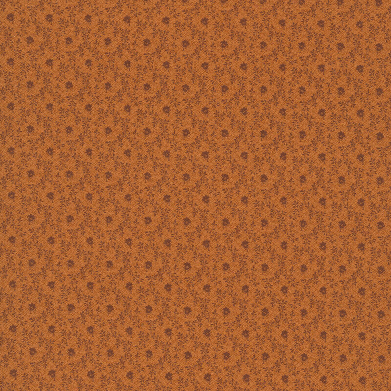 Tonal burnt sienna fabric featuring a small flower inside a vine lattice design.