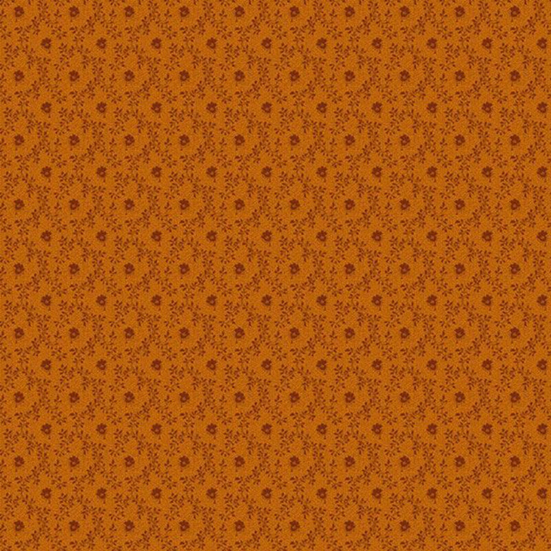 Tonal burnt sienna fabric featuring a small flower inside a vine lattice design.
