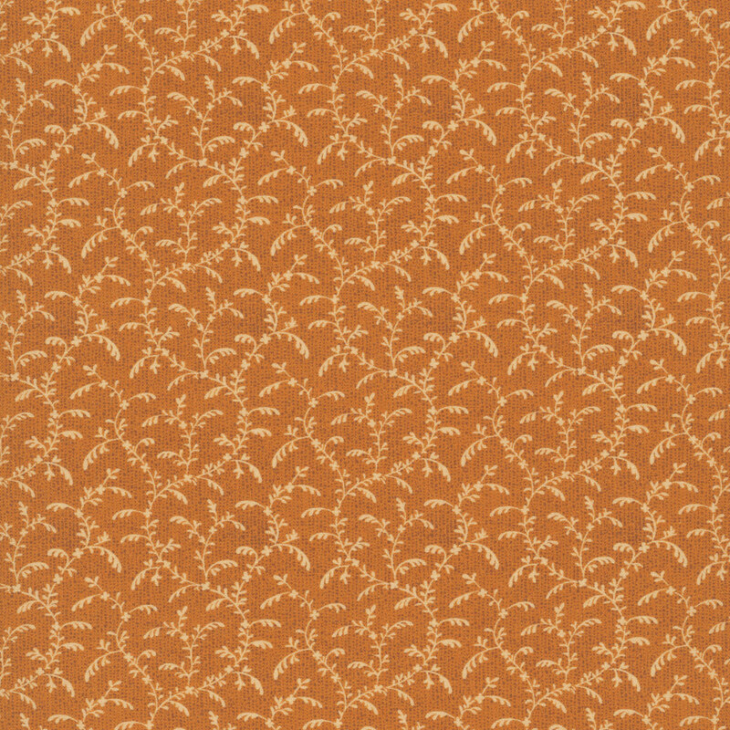 Cinnamon colored fabric with orange swirling, leafy vines.