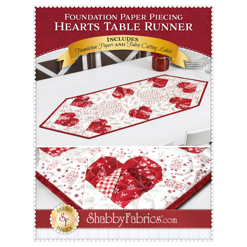 The front cover of the pattern, showing the completed Foundation Paper Piecing Hearts Table Runner, colored in red and white fabrics from the Redberry Lane collection by Henry Glass Fabrics, staged on a wooden dining table with white chairs in a bright kitchen as well as a close up detail shot.