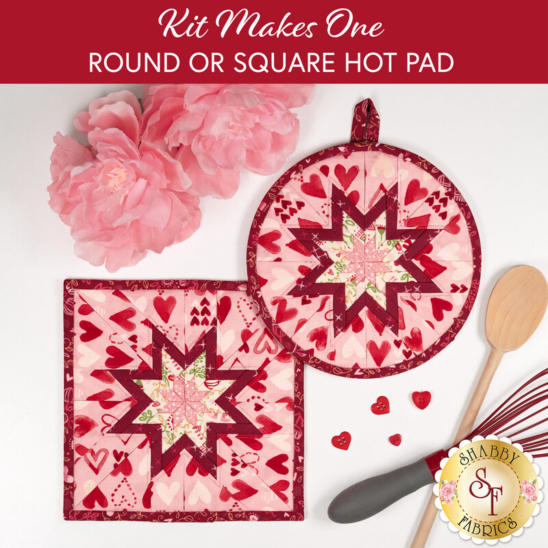 A top down shot of the completed square and circle Hot Pads colored in bold pink, red, and cream fabrics from the Darling Peony collection by Moda Fabrics, staged on a white countertop with coordinating flowers and kitchen utensils.