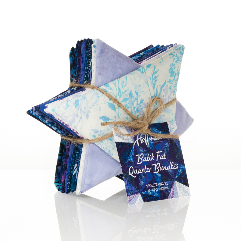 Star shaped Bundle of folded batik fabric fat quarters tied with twine and a decorative tag.