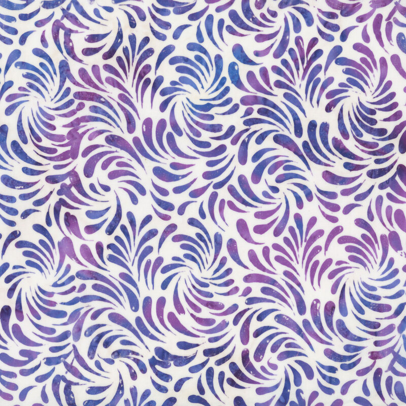 White batik fabric featuring a swirling design of brush strokes in mottled hues of violet and blue.