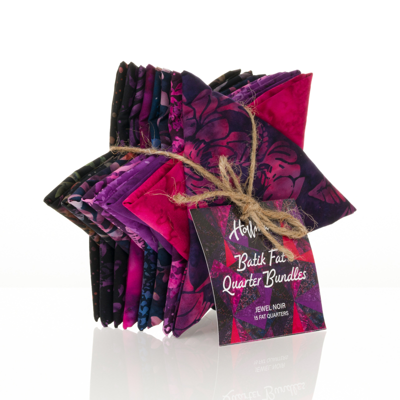 Star shaped Bundle of folded batik fabric fat quarters tied with twine and a decorative tag.