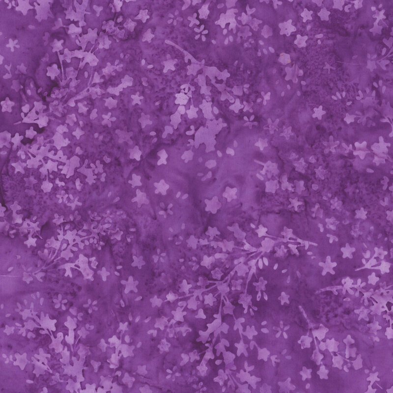 Mottled, deep purple batik fabric featuring flower silhouettes.