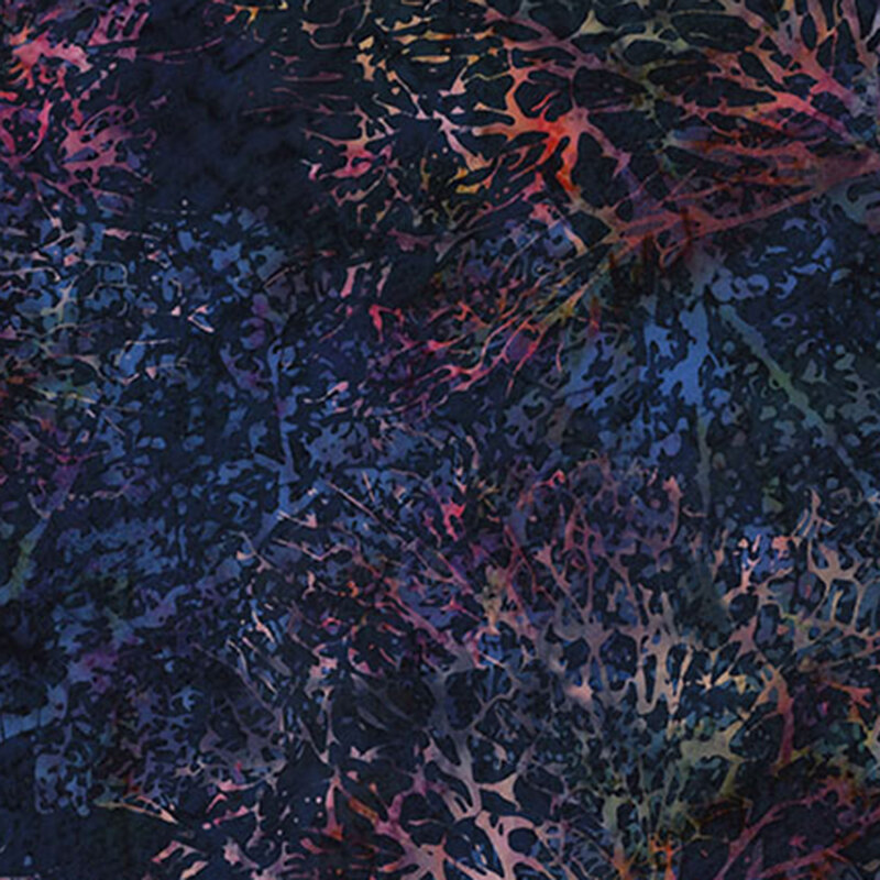 Mottled dark navy blue batik fabric featuring dense branches in mottled rainbow hues.