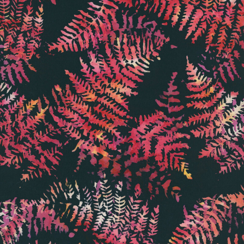 Black batik fabric featuring large fern leaves in mottled hues of red, orange, and yellow.
