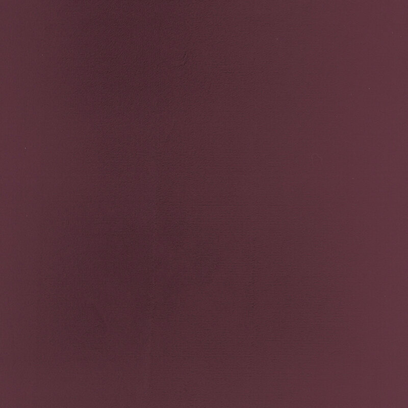 Solid swatch of dark wine red Cuddle fabric.
