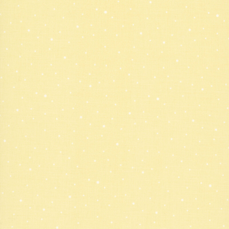 A pastel yellow fabric with scattered small white dots.