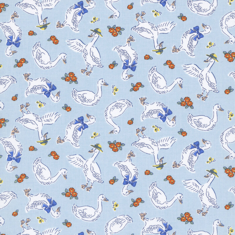 Pastel blue fabric with a pattern of white geese wearing blue bows and yellow hats, along with orange and yellow flowers