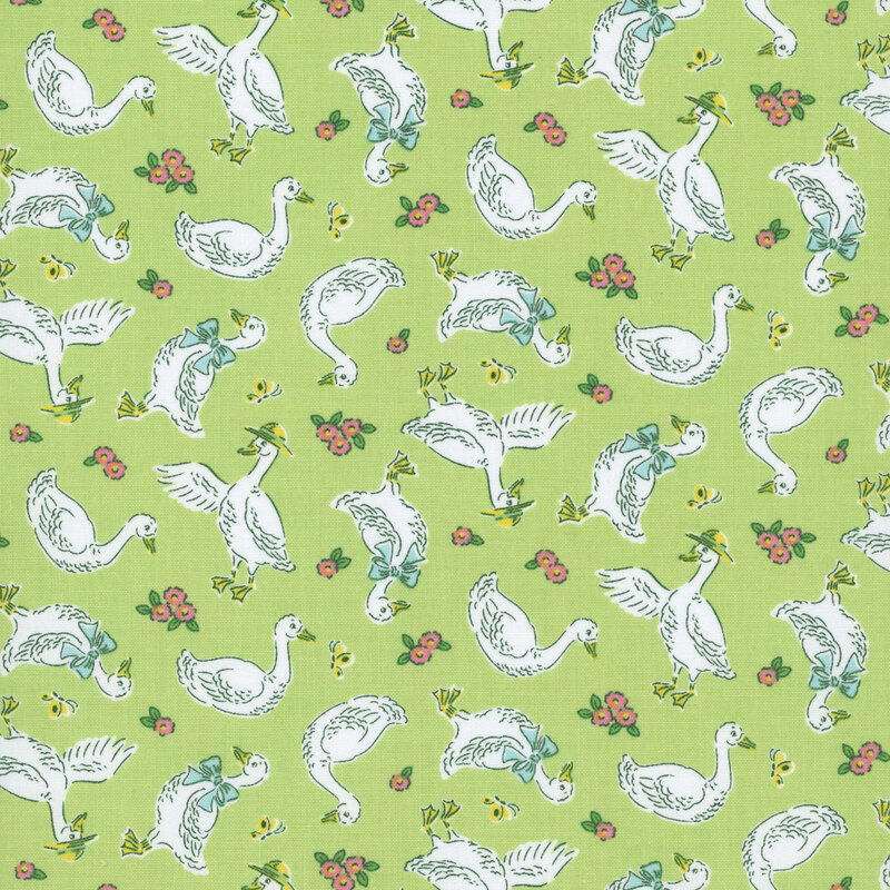 Spring green fabric with a pattern of white geese wearing light blue bows and yellow hats, along with blush pink and pale yellow flowers