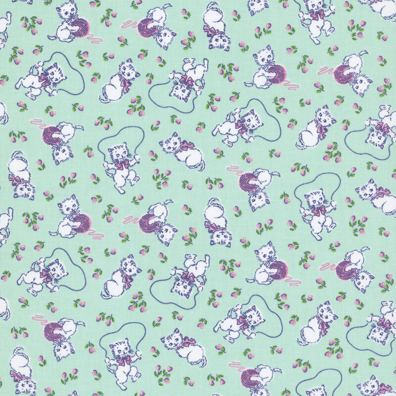 Turquoise fabric with white kittens with pastel pink bows playing with lavender purple balls of yarn and jumping rope, with small pink tulips