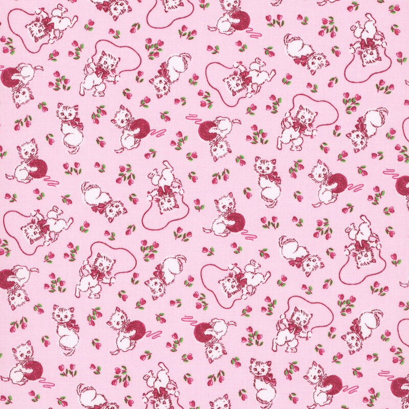 Ballet pink fabric with white kittens with hot pink bows playing with hot pink balls of yarn and jumping rope, with small pink flowers