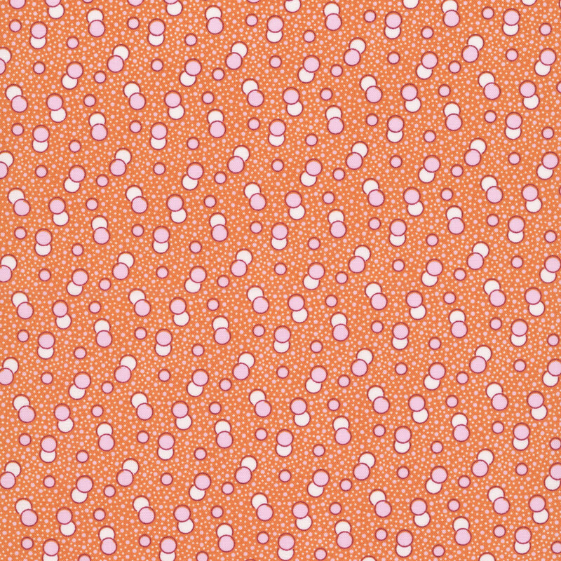 Tangerine orange fabric with a primitive pattern of pastel pink and white circles