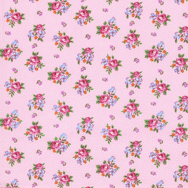 Vintage inspired fabric with bunches of pink roses and blue flowers, small pink floral buds, and pin dots on a ballet pink background
