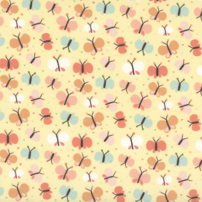 Pale yellow fabric with a pattern of cartoonish butterflies in coral, orange, turquoise, and white