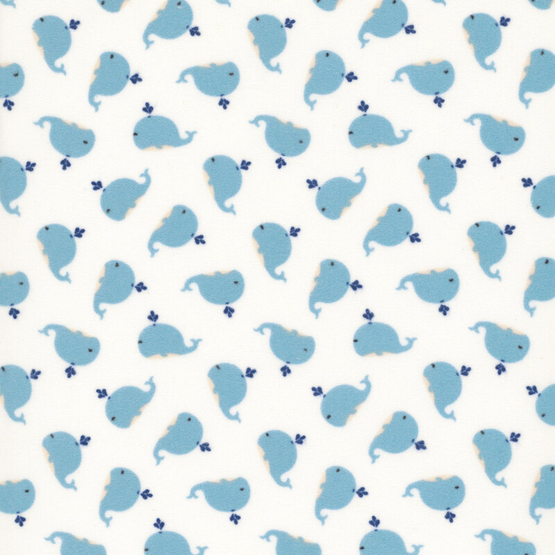 white fabric with tiny variegated pindots and a ditsy pattern of cute blue whales