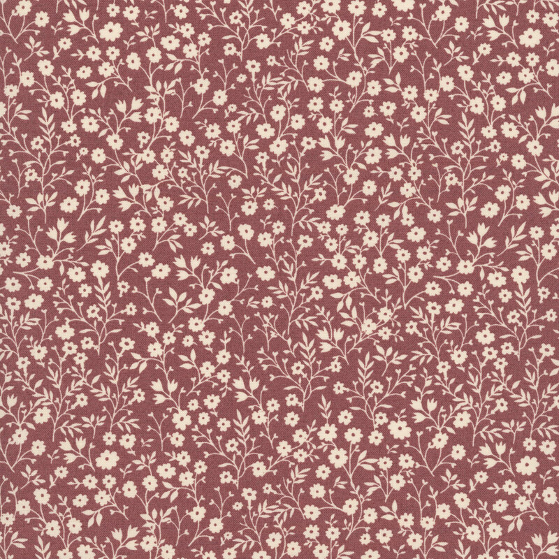 Deep cherry fabric with a dense pattern of cream flowers and stems