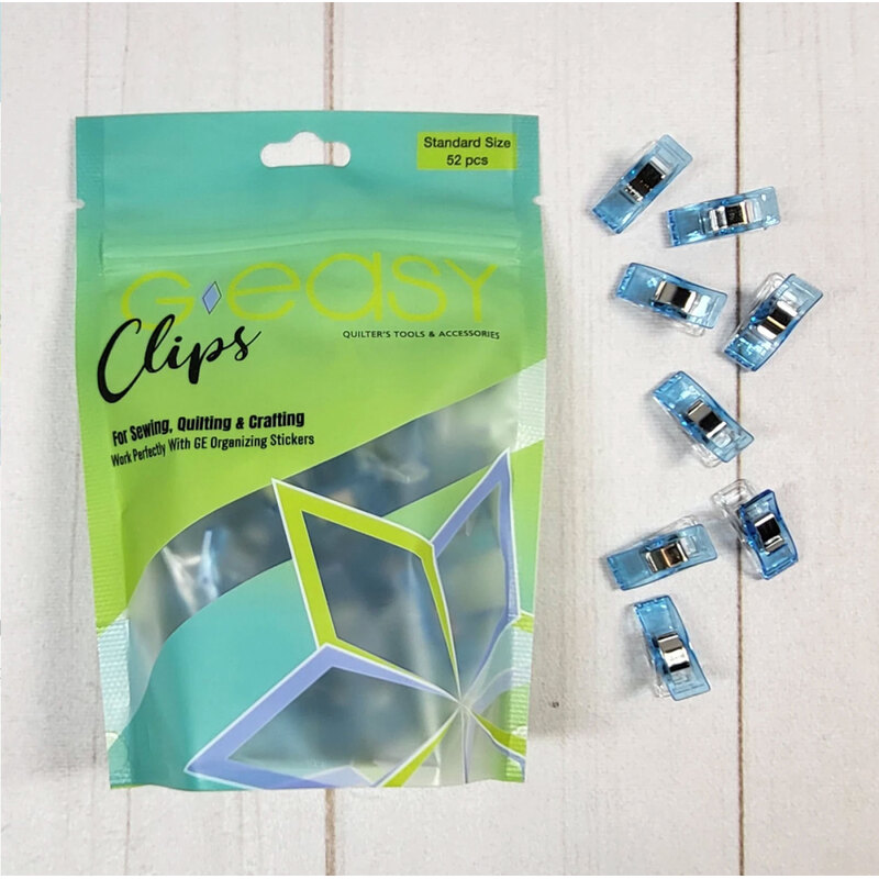 Clear packaging of Easy Clips for sewing, quilting, and crafting, with blue clips displayed around it.