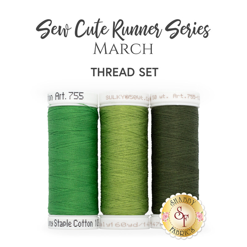 The coordinated thread set for the Sew Cute Runner - March table topper. Three green spools of thread sit next together beneath stylized text.