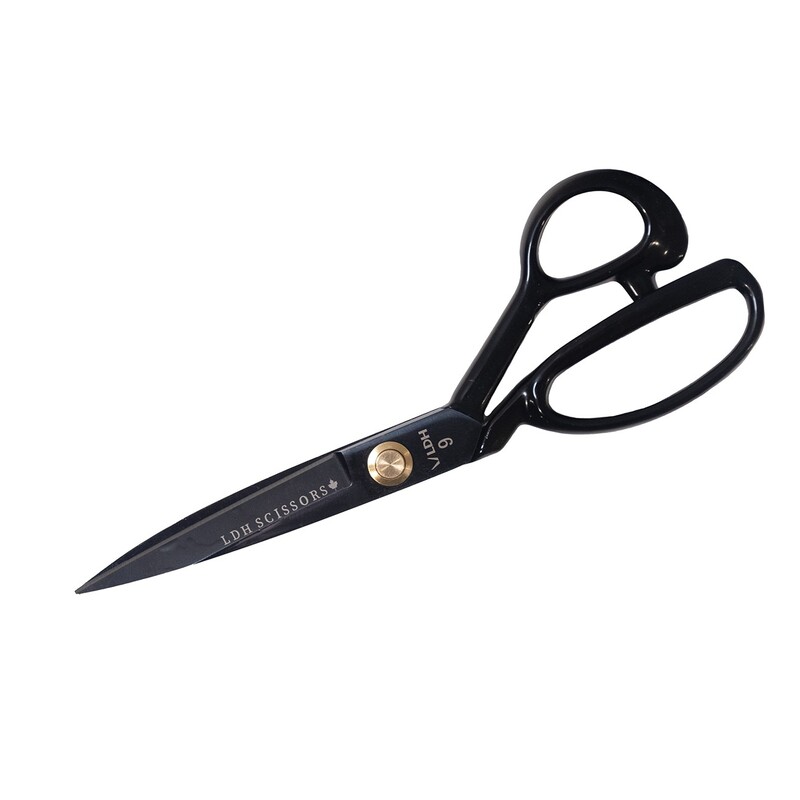 A pair of black scissors with a gold tension screw and labeled LBR Scissors.