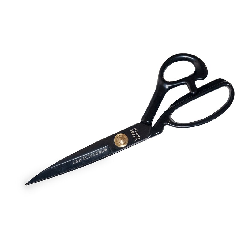 A pair of black scissors with a gold rivet, positioned with the blades open.
